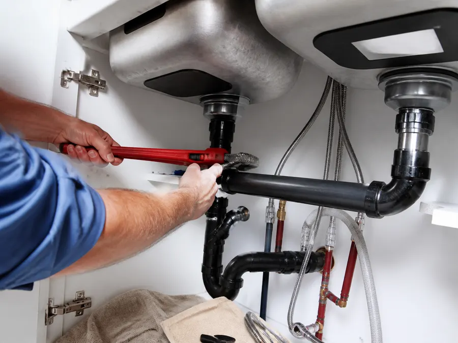 Plumbing repair under a residential sink in Dallas-Fort Worth